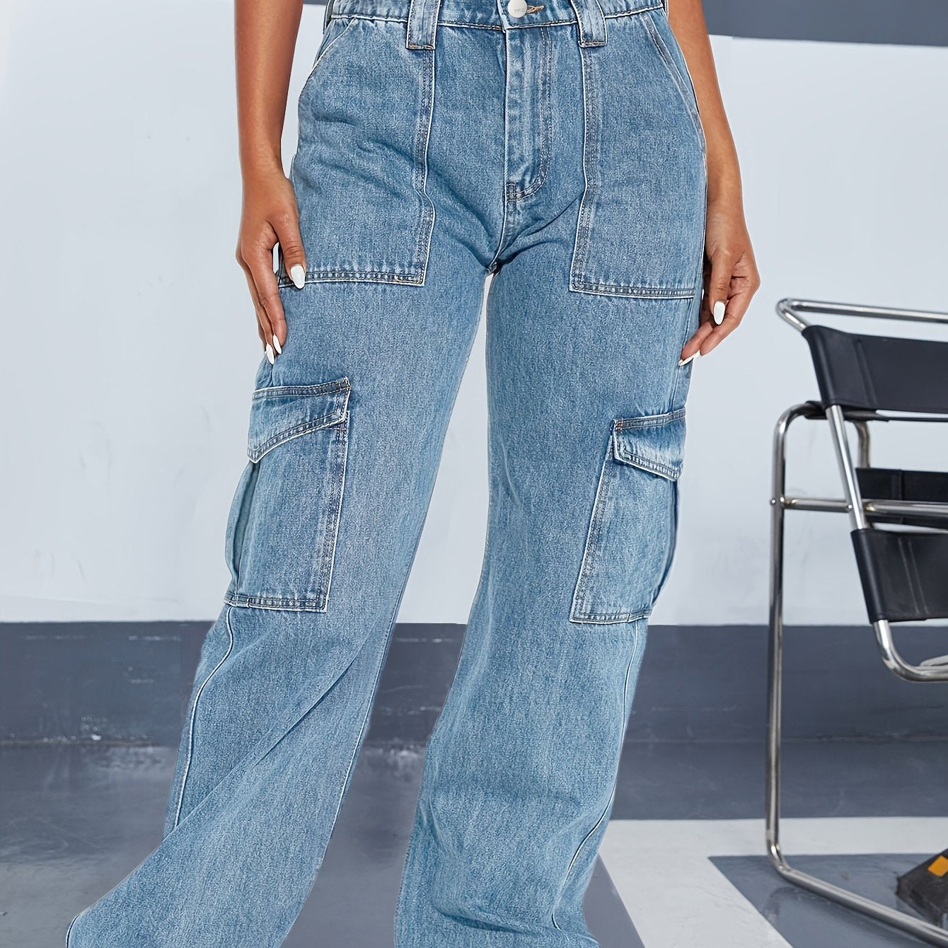 Plus size loose fit cargo jeans with stylish side flap pockets; comfortable streetwear denim pants with relaxed leg for women.