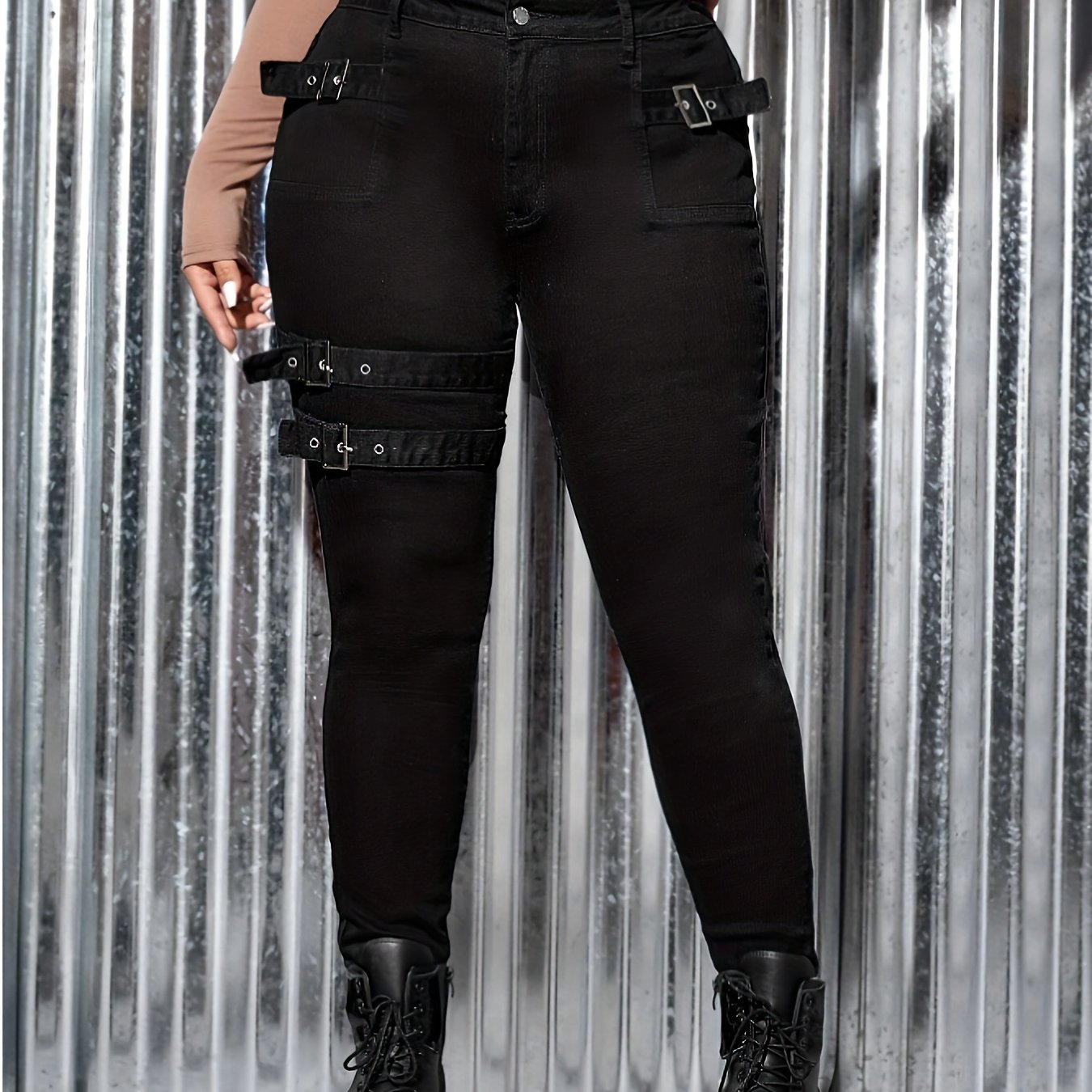 Women's plus size high waist black skinny jeans with stylish straps and pockets, featuring medium stretch and flattering fit for curvy figures.