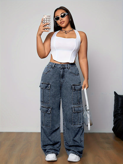 Stylish woman wearing plus size cargo jeans with multi-pocket design and loose fit, paired with a white tank top, taking a selfie.