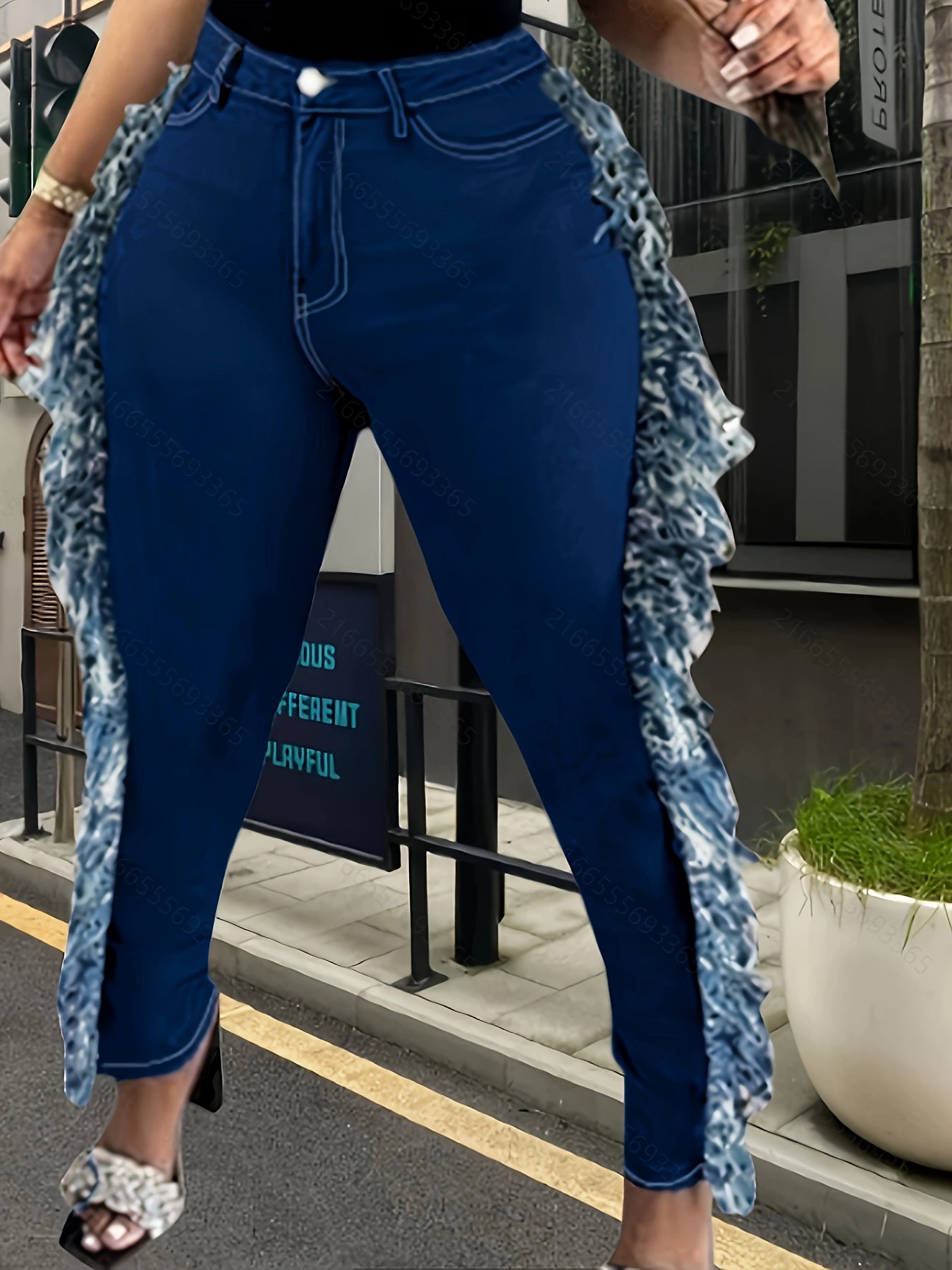 Plus size high-waist skinny denim pants with raw hem detail and tassel fringe for women, featuring a stretchy fabric and solid color design.