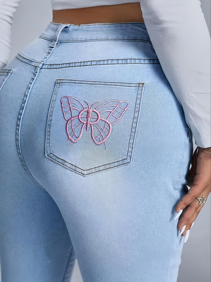 Plus size women's denim jeans with embroidered pink butterfly on back pocket, flare leg style, stretch material, casual wear.