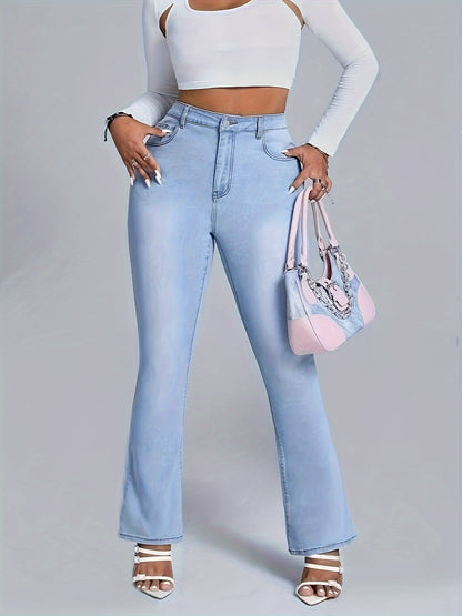 Woman in light blue flare jeans holding a pink handbag, wearing white top and heels