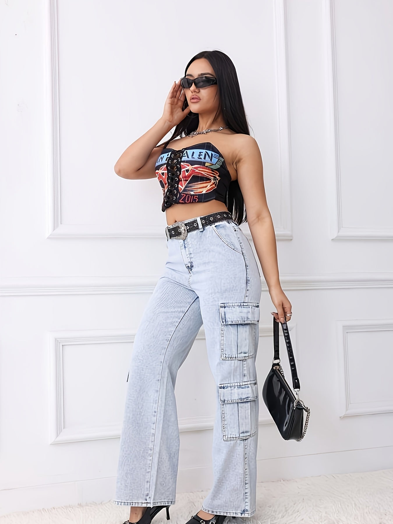 Woman in retro style cargo pants and crop top, showcasing blue straight jeans with four pockets, set against a stylish backdrop.