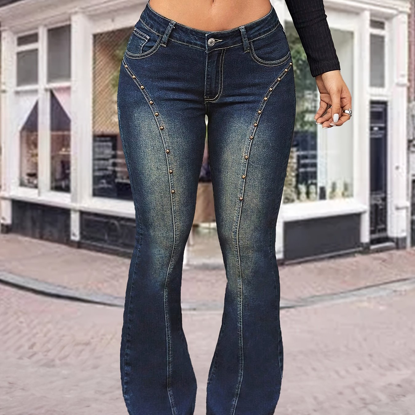 Plus size women's high-waist flared denim jeans with button details, stretchy fabric, and casual chic style for fall and winter.