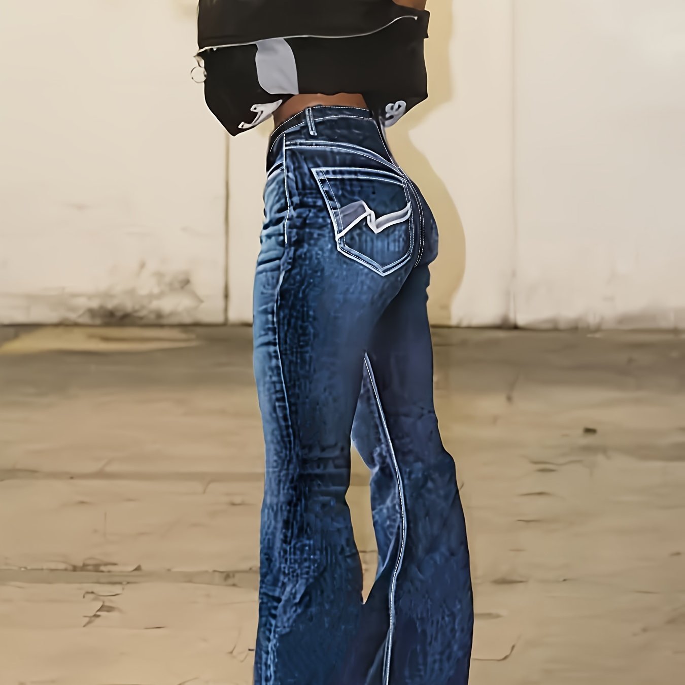 Plus size flare leg embroidered jeans with raw hem, comfortable denim fabric, and geometric back pocket design for women's casual wear.