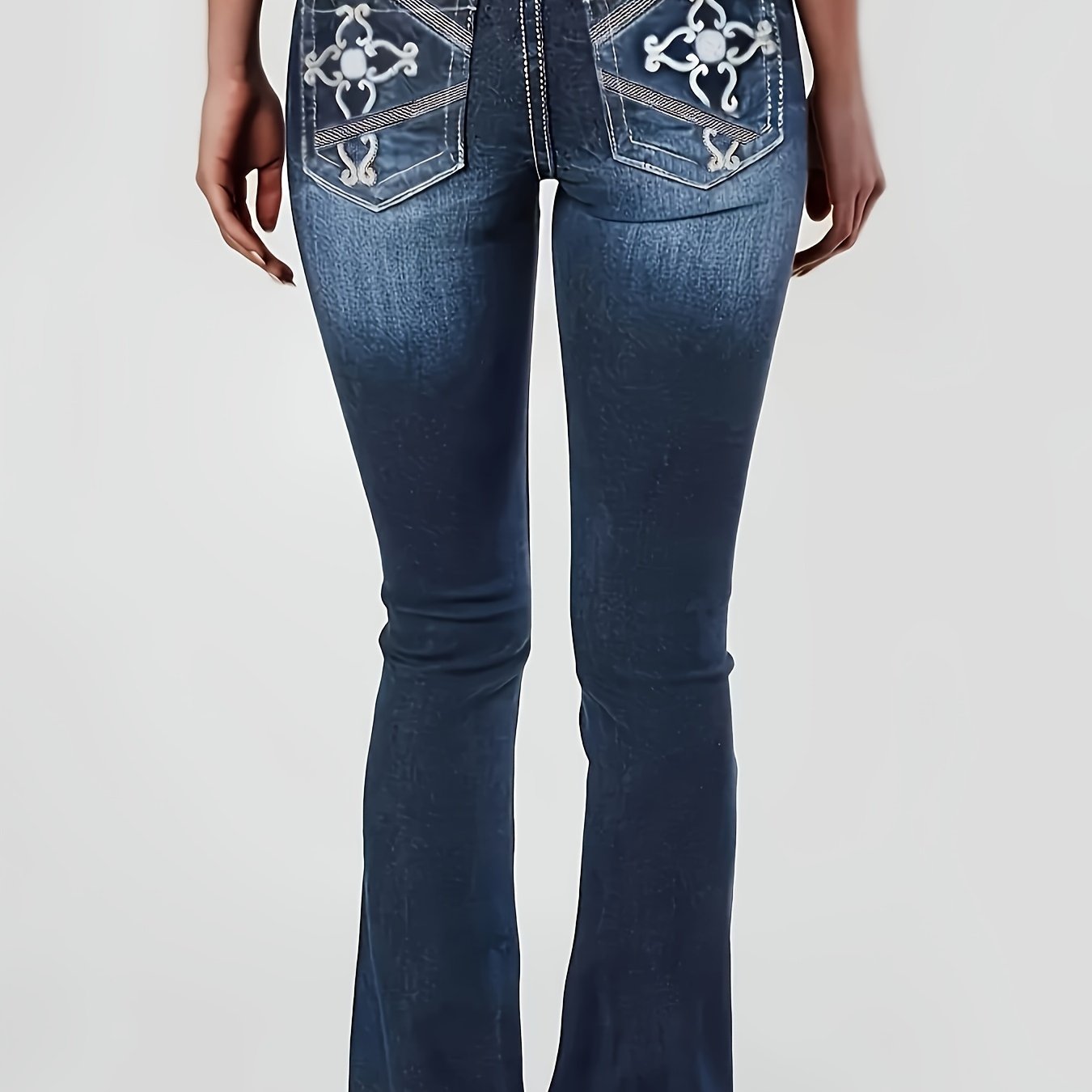 Women's plus size embroidered bell bottom jeans with geometric pattern showcased from the back, casual stretch denim, all-season fashionable flare pants.