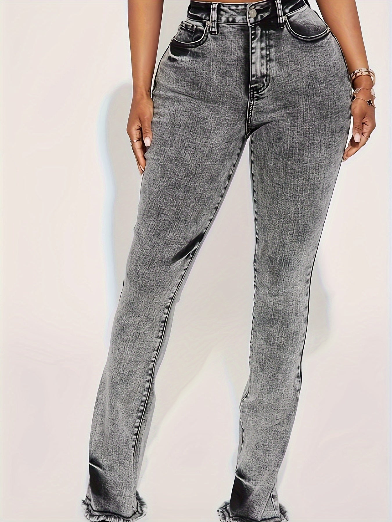 Women's plus size grey wash flare jeans, elastic waist, stretch denim, bell bottoms with frayed hem, casual style.