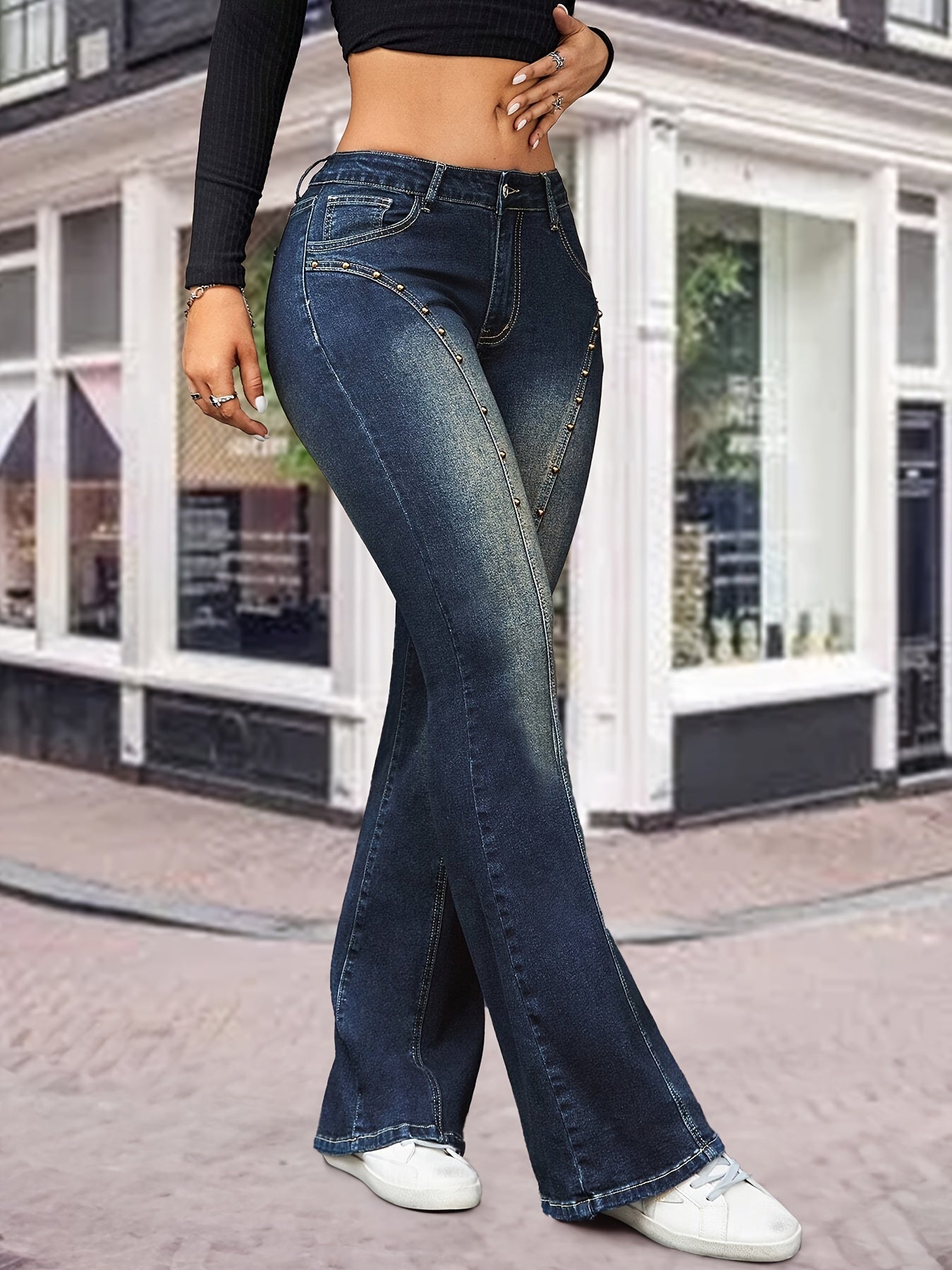 Plus size women's flared denim jeans with high waist, stretchy material, bell-bottom cut, pocket detail, and casual chic style for fall and winter.