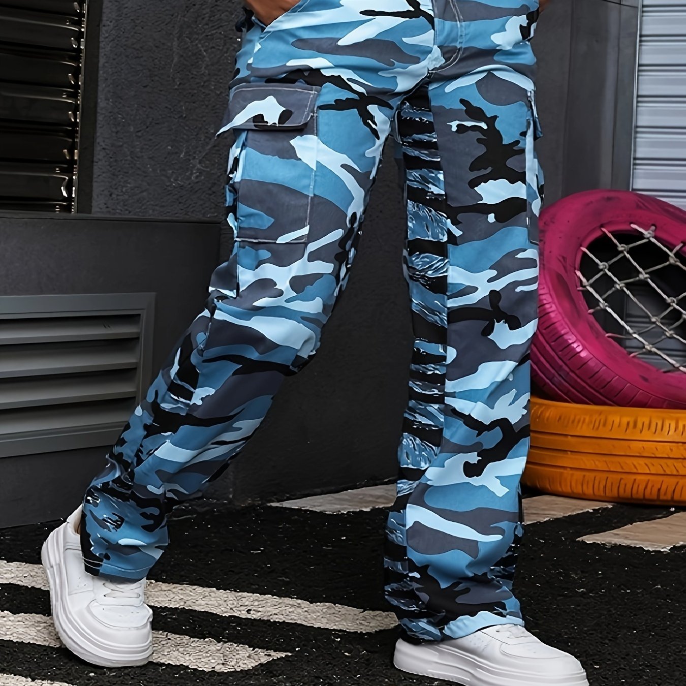 Plus size camo print streetwear cargo jeans with side flap pockets, distressed denim, and loose fit, showcased with white sneakers.