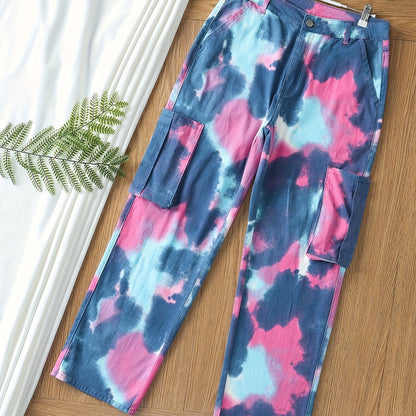 Plus size women's tie-dye cargo jeans with high stretch, multiple pockets, button fly, and relaxed fit on a wooden floor background.